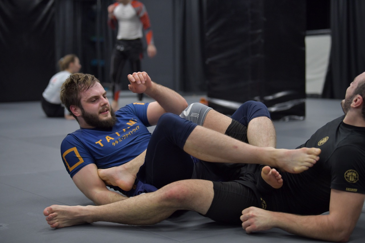 Grappling athletes drilling control and transitions for MMA